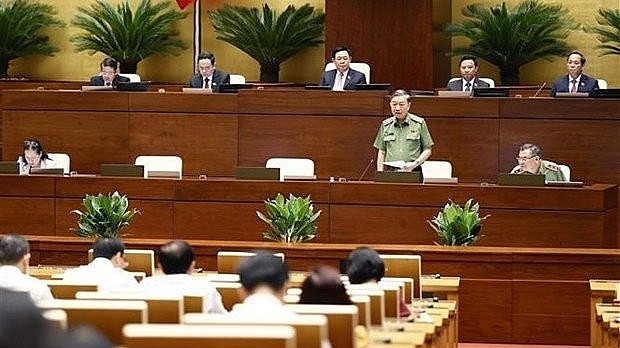 Minister of Public Security Gen. To Lam answers questions from lawmakers on August 10. Photo: VNA