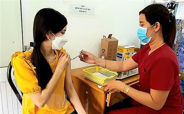 A woman gets vaccinated against COVID-19 in Soc Trang province. Photo: VNA