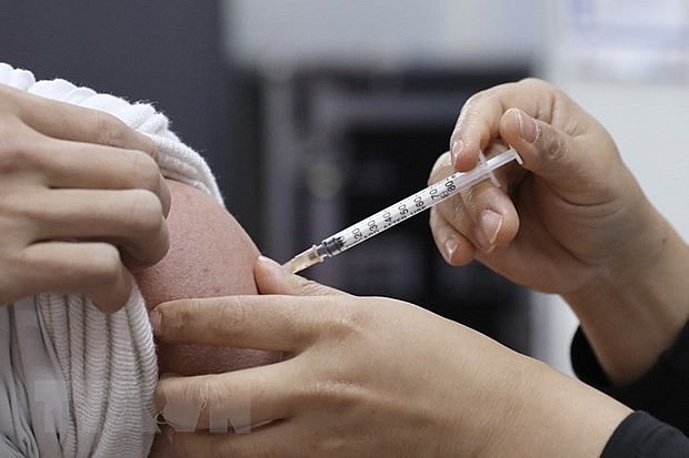 Getting vaccinated against Covid-19. Photo: VNA