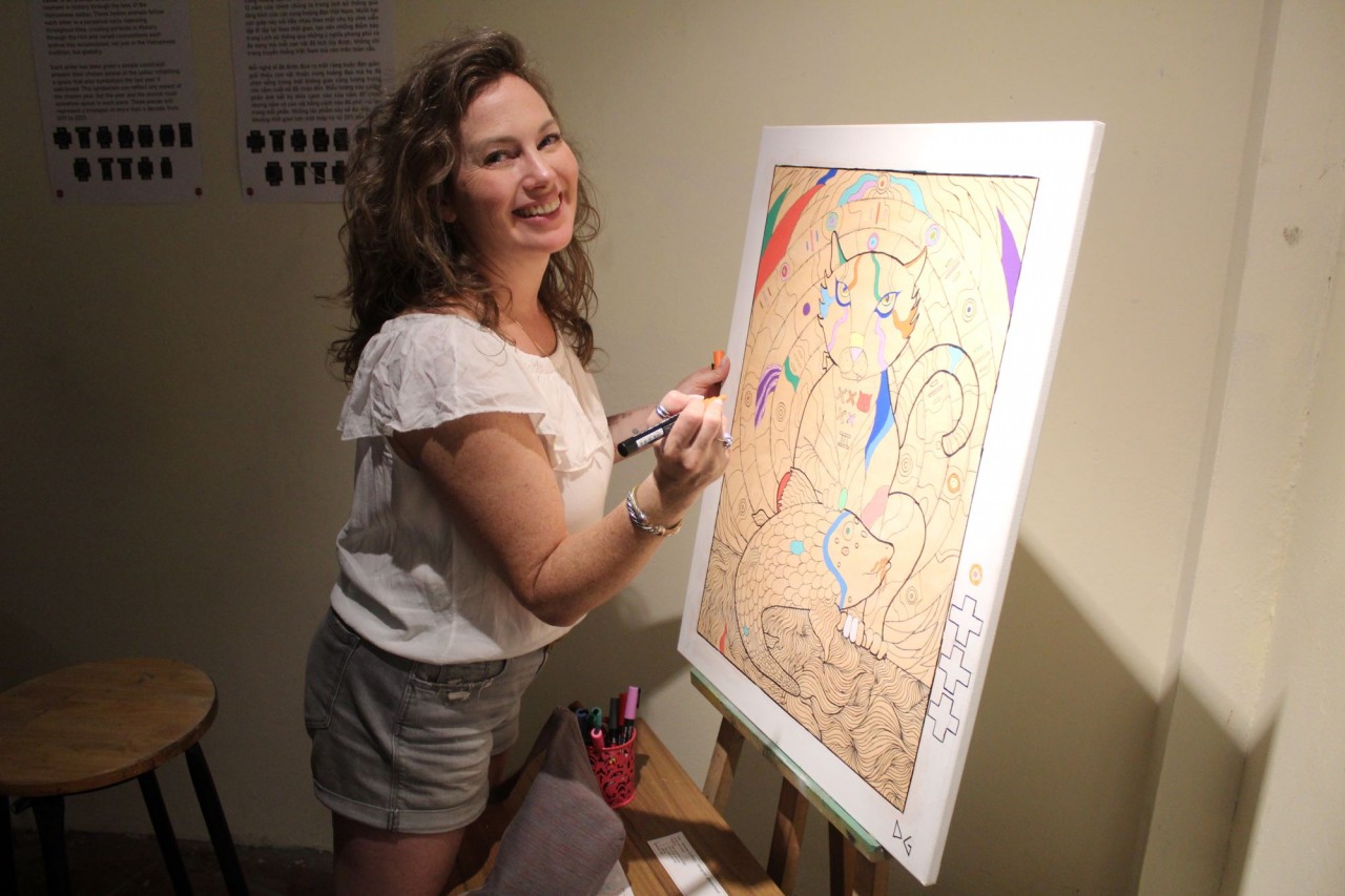 A visitor contributes to depicting the coming Year of the Cat (Photo: Jason Law)