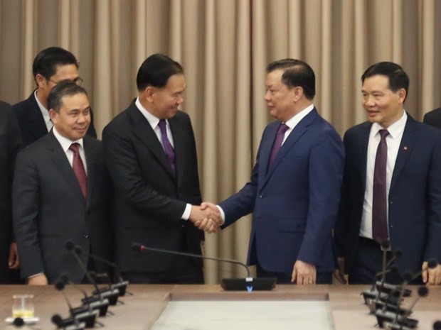 Politburo member and Secretary of the Hanoi Party Committee Dinh Tien Dung and Secretary of the Lao People’s Revolutionary Party (LPRP) Central Committee and chief of the LPRP Central Committee’s Office Thongsalith Mangnomek on February 17. Photo: VNA