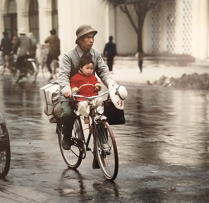 In the photo: Thomas captured a man with his baby on a bicycle in Hanoi during the 1970s.