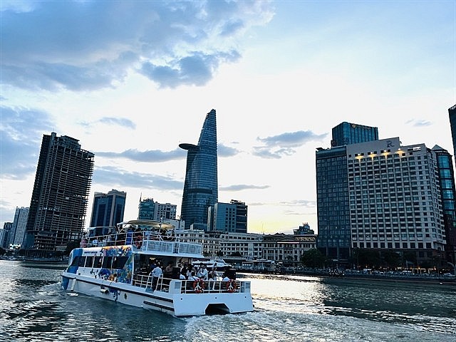 Visitors explore the Sài Gòn River by a double-decker water bus. — VNA/VNS Photo