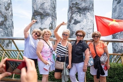 Foreign tourists pose for a photo on the world-famous Golden Bridge inside Ba Na Hills Sun World complex in Da Nang city.