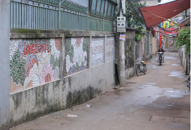 Colorful village road created by discarded bottles and scrap