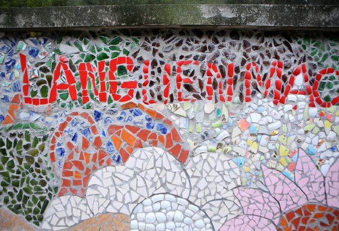 Colorful village road created by discarded bottles and scrap