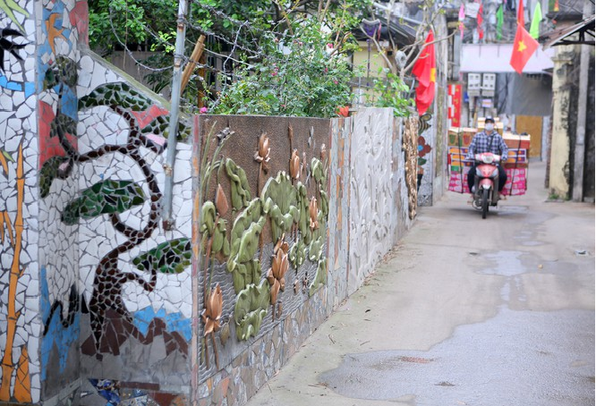 Colorful village road created by discarded bottles and scrap