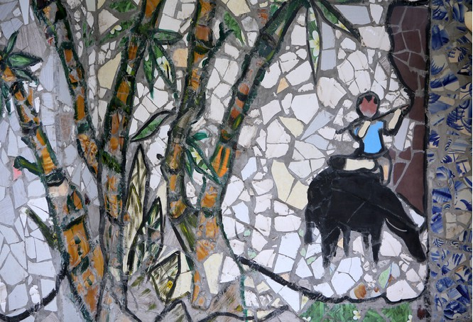 Colorful village road created by discarded bottles and scrap