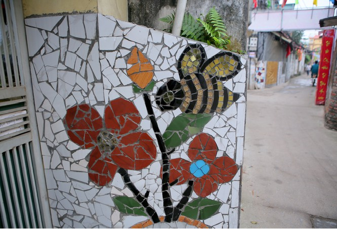 Colorful village road created by discarded bottles and scrap