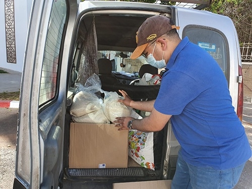  a representative from enamaa collects the donation