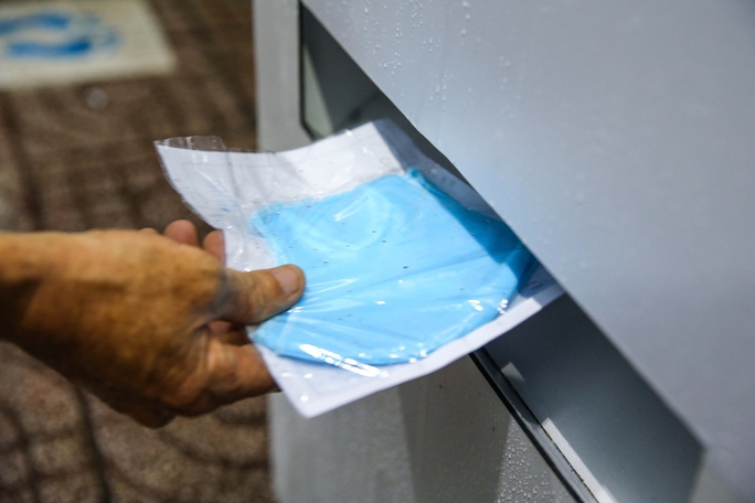 The machine  automatically dispenses out one antibacterial cloth face mask at a time 