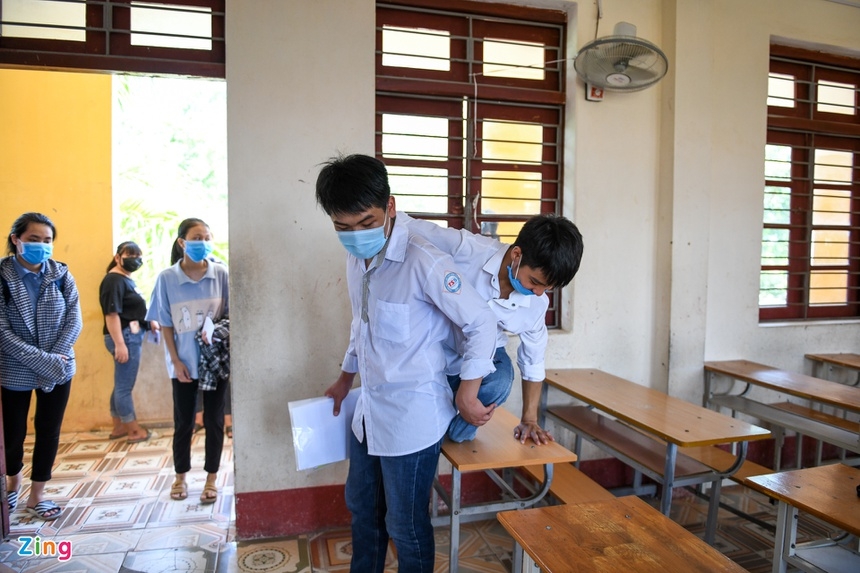 Boy carries handicapped friends piggyback to school over 10 years Hieu taking Minh to his designated seat on the exam day