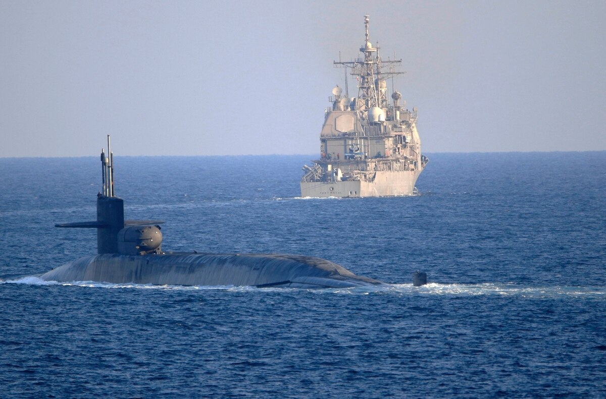The guided-missile submarine USS Georgia, front, with the guided-missile cruiser USS Port Royal, transits the Strait of Hormuz in the Persian Gulf on Dec. 21, 2020 (Photo: AP)  