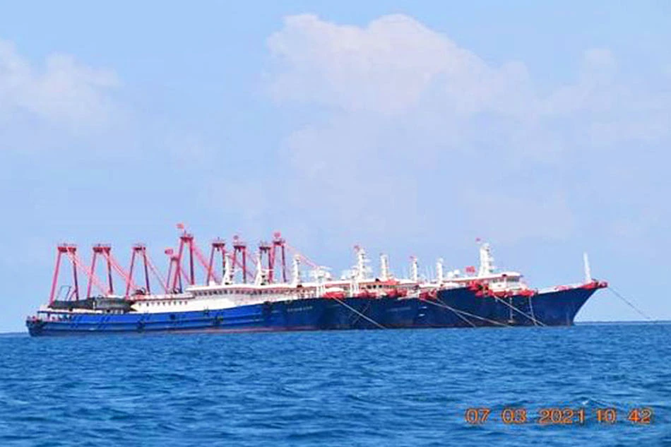 Some of the about 220 Chinese vessels reported by the Philippine Coast Guard, and believed to be manned by Chinese maritime militia personnel, are pictured at Whitsun Reef, South China Sea, March 7, 2021. Philippine Coast Guard/National Task Force-West Philippine Sea/Handout via Reuters/file