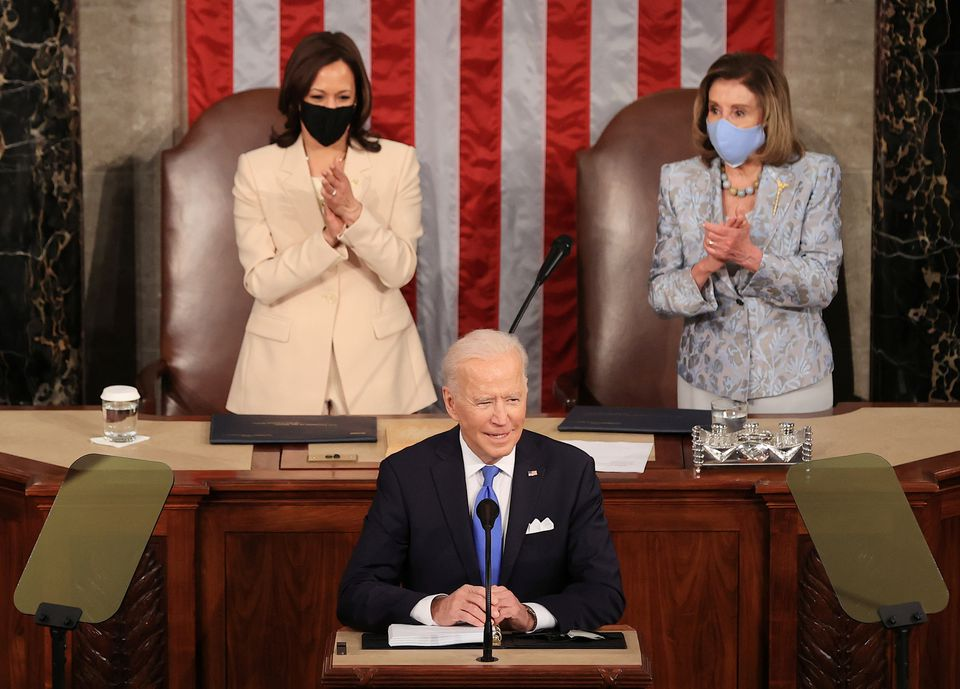 U.S. President Joe Biden addresses a joint session of Congress as President Kamala Harris and Speaker of the House U.S. Rep. Nancy Pelosi (D-CA) react in the U.S. Capitol in Washington, DC, U.S. April 28, 2021. Chip Somodevillaat/Pool via REUTERS
