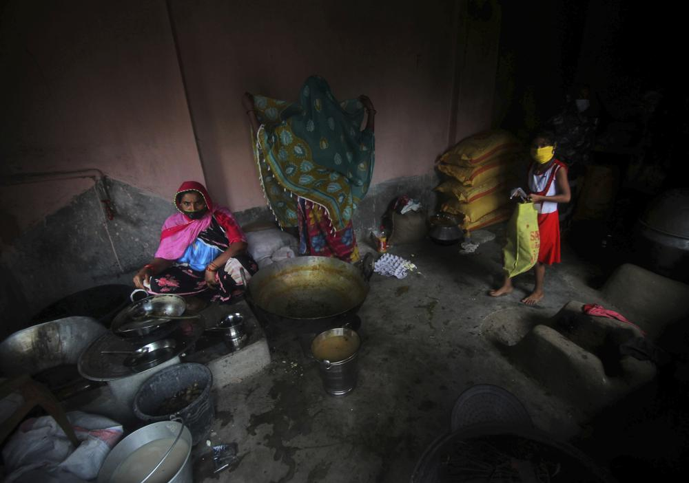 Village women who have taken refuge at a cyclone shelter prepare a meal in Balasore district in Odisha, India, Tuesday, May 25, 2021. Tens of thousands of people were evacuated Tuesday in low-lying areas of two Indian states and moved to cyclone shelters to escape a powerful storm barreling toward the eastern coast. (AP Photo)