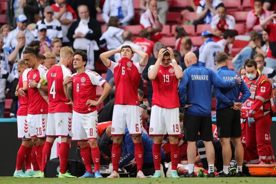 Denmark's players react as paramedics attend to Denmark's midfielder Christian Eriksen on Saturday. Friedemann Vogel / AFP - Getty Images