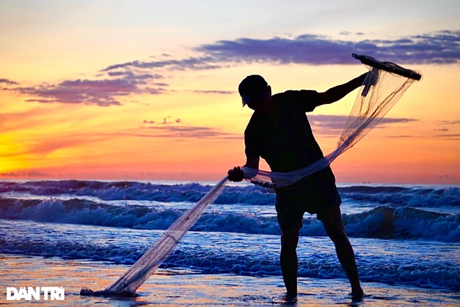 It’s not unusual to capture the images of the fishers raking clams in the hours before the sunrise. Photo: Dantri 