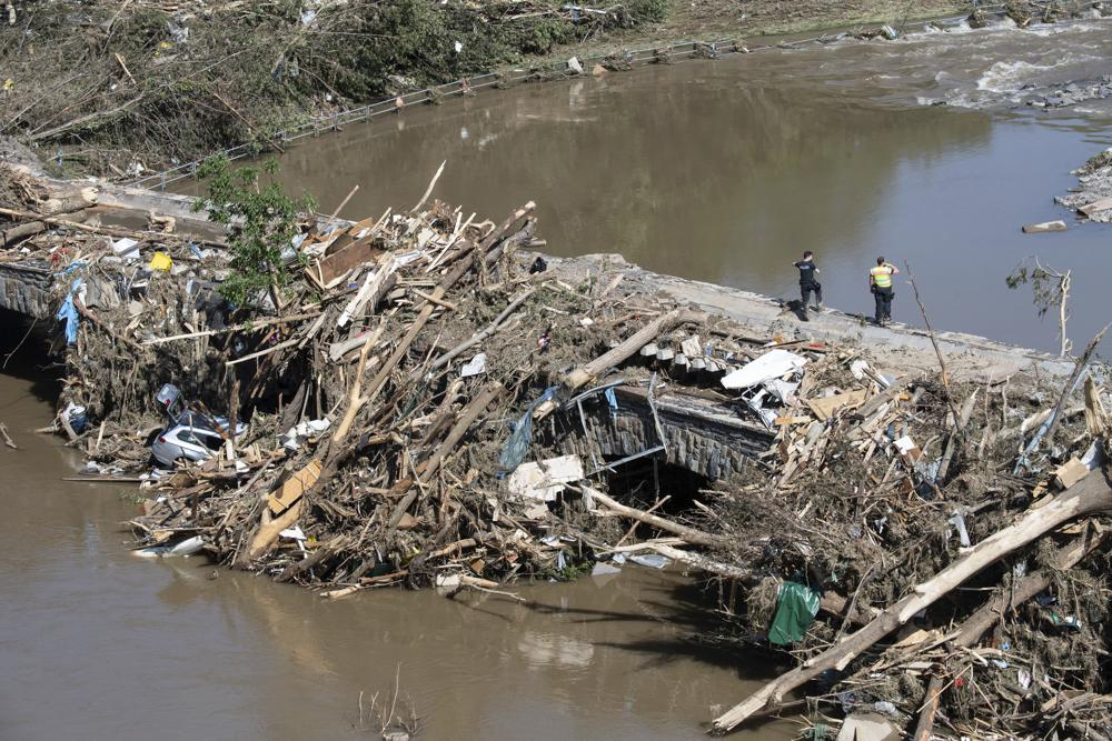 Police officers search in the rubble for possible victims, at a bridge over the River Ahr, in Altenahr, western Germany, Sunday, July 18, 2021. Photo: AP 
