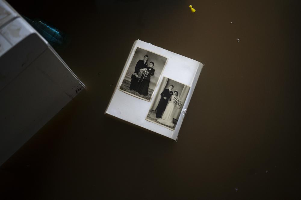 A view of wedding photos floating in water in a flooded basement of a home, in the town of Brommelen, Netherlands, Saturday, July 17, 2021. Photo: AP 
