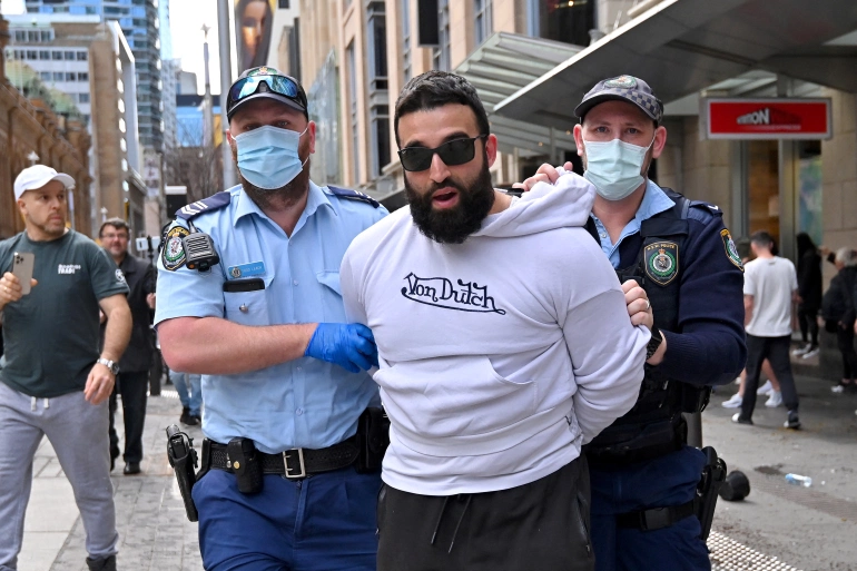 Police officers in Sydney detained several protesters [Steven Saphore/AFP]