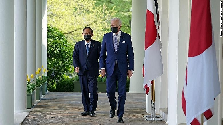 US President Joe Biden and Japan's Prime Minister Yoshihide Suga walk through the Colonnade to take part in a joint press conference in the Rose Garden of the White House in Washington, DC on April 16, 2021.