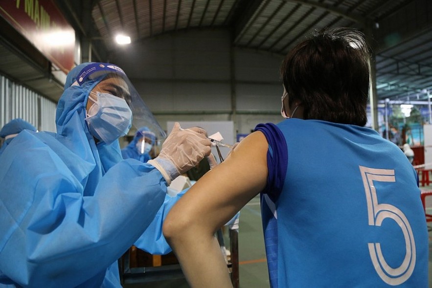 A local resident in HCM City receives a shot of Vero Cell COVID-19 vaccine. Photo: plo.vn