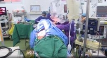 woman plays violin as surgeons remove brain tumor