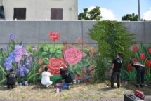 vietnamese artists decorate dyke wall along seine river bank