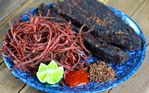 dishing out buffalo meat hung up in kitchen in northwestern provinces